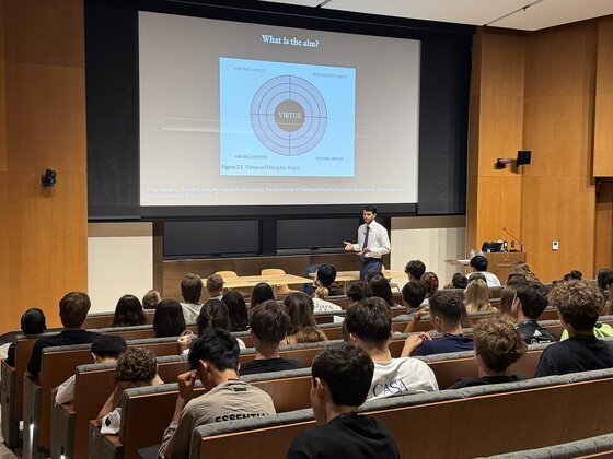 Christian Carmody delivering a keynote to a full auditorium